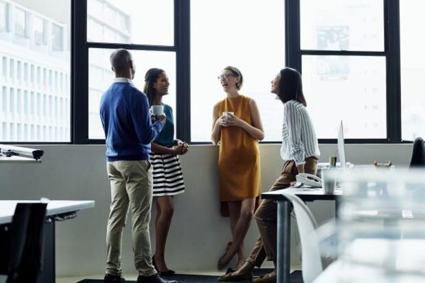 Group of people drinking coffee in an office 